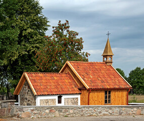 General view and architectural details of a brick Catholic chapel from 1863 and a wooden part added...