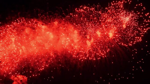4K.Real fireworks background. Shining fireworks in the night sky. Glowing sparkles. New year's eve fireworks celebration. Colorful New Year Firework 