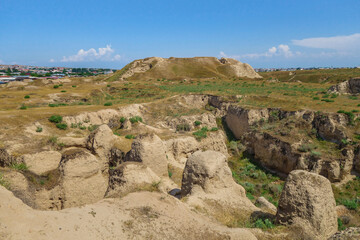 Excavations of Afrasiyab, most ancient site in Samarkand, Uzbekistan. Hill on background is former citadel with royal palace and fortress. Founded in VIII BC. Modern city is on far background