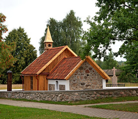 General view and architectural details of a brick Catholic chapel from 1863 and a wooden part added...