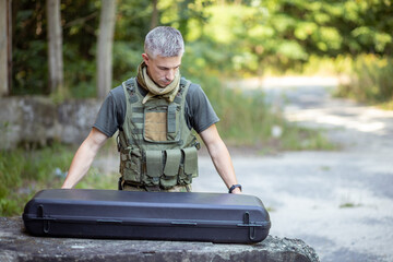 A man preparing for the airsoft game in military uniform