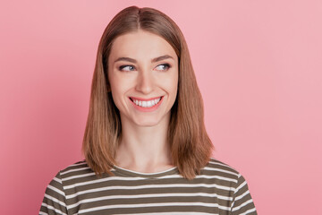 Fototapeta premium Portrait of interested funny lady look side empty space toothy smile on pink background