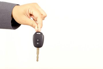 Salesman is carrying the car keys delivered to the customer at the showroom with a low interest offer. Special promotion