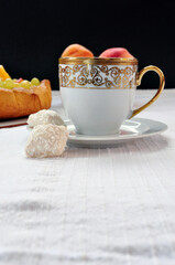 Sweet breakfast, lovely golden cup on a plate and candies , free space for text