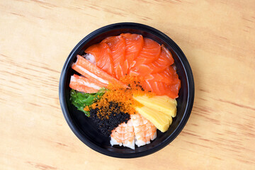 Japanese Rice with Salmon and Tobiko on wooden background