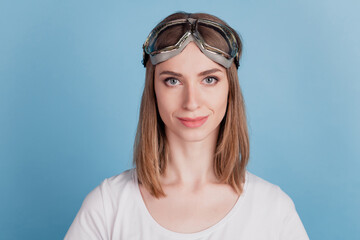 Portrait of positive lovely adorable confident lady wear sport glasses on blue background