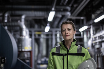 Portrait of female engineer working in an industrial plant room