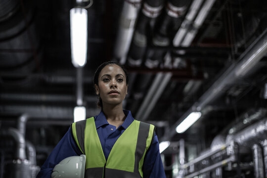 African American female engineer working in an industrial plant room