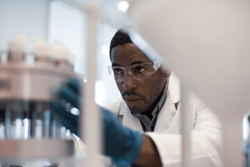 African American male scientist looking at test samples in a laboratory