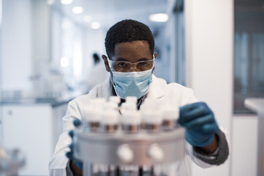 African American male scientist looking at test samples in a laboratory
