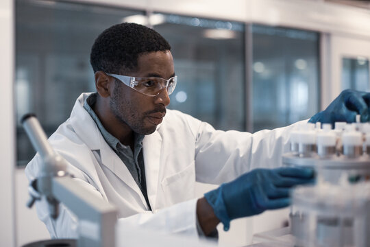 African American male scientist looking at test samples in a laboratory