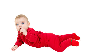 A blue-eyed little child on a white blanket with a Christmas toy in his hands. Isolated