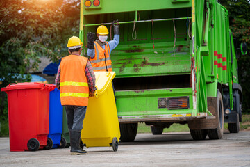 Rubbish cleaner man working with green garbage truck loading waste and trash bin at city,Waste...