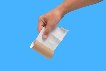 Used roll toilet paper in your hand on blue background.Concept an emergency situation and a...
