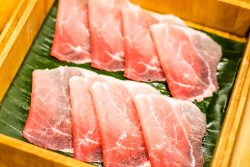 Sliced pork set in a wooden bowl inside the restaurant