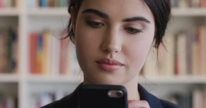 Portrait beautiful woman student using mobile phont in library