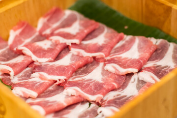 Sliced pork set in a wooden bowl inside the restaurant