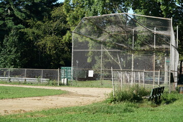 Baseball metal backstop and field in park in summer