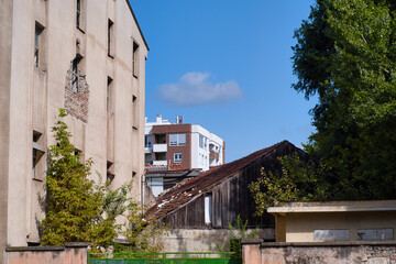 Fototapeta na wymiar Social problems of growing city of Novi Sad, Serbia - historic poor house and new high rise building
