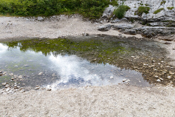 water source at the foot of the Marmolada. Alps, Dolomites, Passo Fedaia, Belluno, Italy