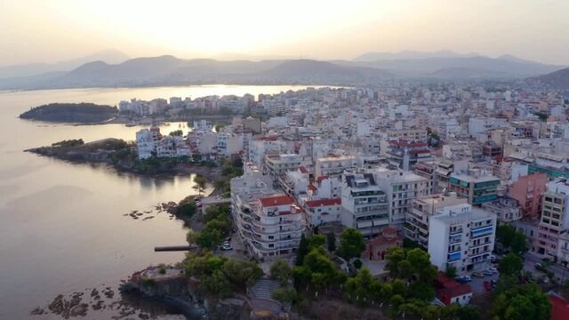 4k drone forward video (Ultra High Definition). Great sunrise in Chalcis town, Greece. Splendid summer seascape of Aegean sea, North Euboean Gulf. Nice morning scene of Euboea island, Greece, Europe..