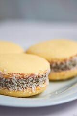 Traditional Argentinian alfajores with dulce de leche on marble table. Argentine gastronomy concept.