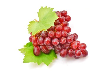 Red grapes with luscious grape leaves on white background.