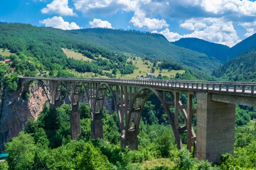 Concrete arch Durdevica Tara Bridge over Tara Canyon River in northern Montenegro.