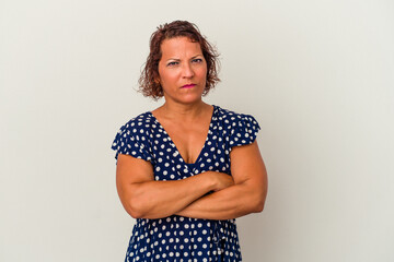 Middle age latin woman isolated on white background frowning face in displeasure, keeps arms folded.