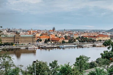 Fototapeta na wymiar View of Prague from Letna Park,Czech Republic.Prague panorama on cloudy rainy day.Amazing European cityscape.Red roofs,towers,Vltava river,historical houses.Travel urban scene.Beautiful sightseeing