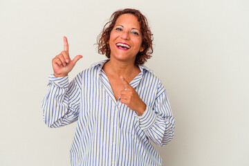 Middle age latin woman isolated on white background dancing and having fun.