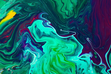 Beautiful liquid texture of the nail polish.Green and purple colors.Multicolored background with copy space.Fluid art,pour painting technique.Good as digital decor.