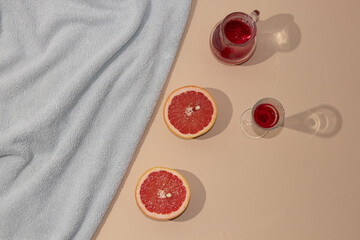 Summer scene with bright blue beach towel and fresh cold drink refreshment concept. Minimal flat lay.
