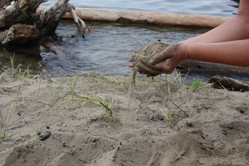 Sand falls out of women's hands.