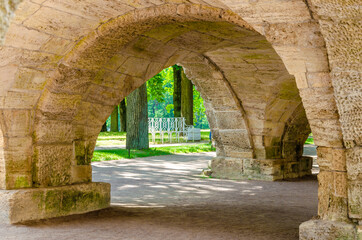 Fototapeta na wymiar Under the arch of the old stone bridge.