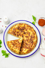 Traditional Spanish tortilla on light background. Space for text, top view.