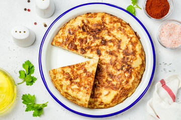 Spanish tortilla on light background. Space for text, top view.