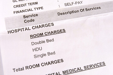 Closeup macro view of an itemized hospital bill for medical services during a hospital stay. A...