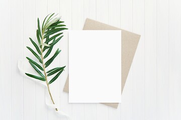 Vertical card mockup, brown envelope, wedding composition with green branch, white ribbon, mock up for invitation, greeting card, menu.