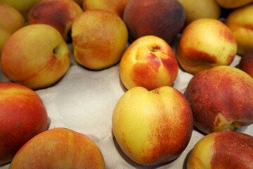 Fototapeta na wymiar juicy ripe nectarine in a box in the supermarket . side view