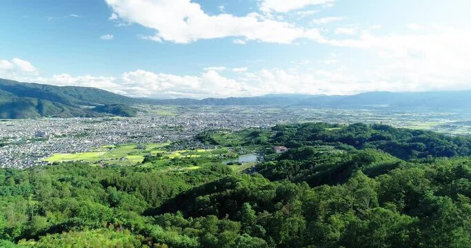 Aerial : Summer sky and small city in Nagano Japan Fly up