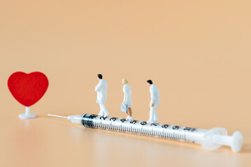 Miniature people Doctor and Nurse emergency medical team walking on syringe with copy space using for digital health retreat take care for covid-19 Coronavirus Immunization vaccinated Hospitality Ads