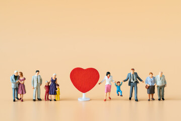 Miniature people Family Father Mother and Children standing near red heart with copy space happiness using for travel around the world business trip traveler adviser agency or valentine day special
