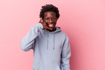 Young african american man isolated on pink background showing a mobile phone call gesture with fingers.