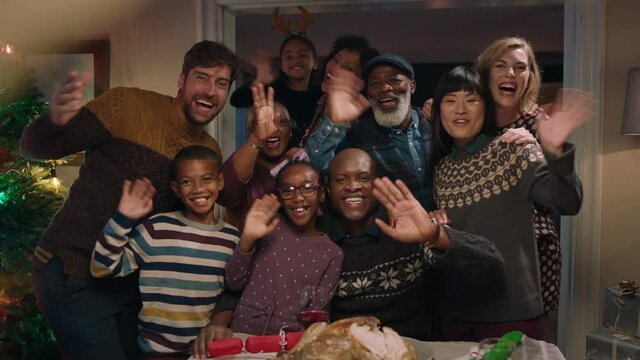 african american family posing for photo with friends at christmas dinner party waving enjoying festive holiday reunion celebrating at home 4k