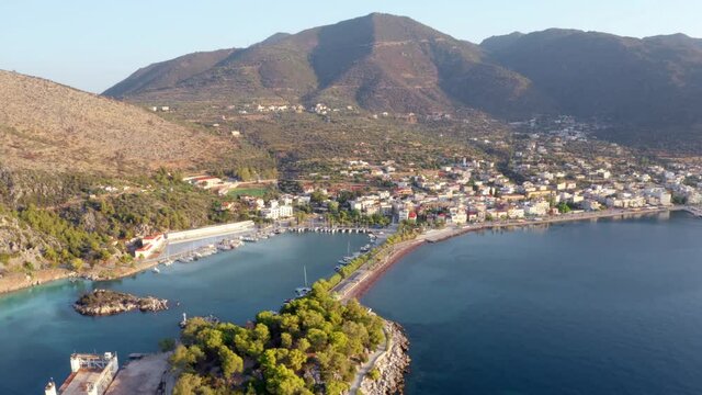 4k drone flight moving to the side footage (Ultra High Definition) of Methana port. Stunning summer scene of Peloponnese peninsula, Greece, Europe. Sunny morning seascape of Ionian sea.