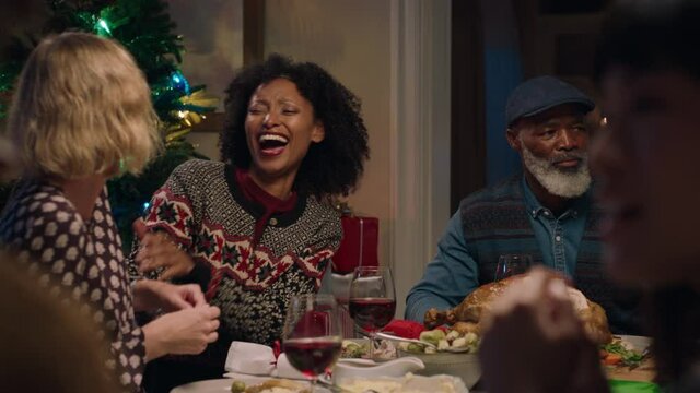 happy best friends enjoying christmas dinner with family two women celebrating festive holiday sitting at table chatting sharing evening meal at home 4k