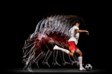 Stroboscope effect. Game. Young professional football player isolated on black background playing