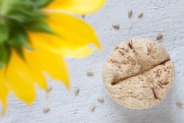 Vegetable-based halva sweet seeds prepared unfocused yellow sunflower background.