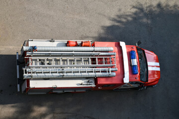 Fire truck, top view from the window of a house or building. View from above - 455321651